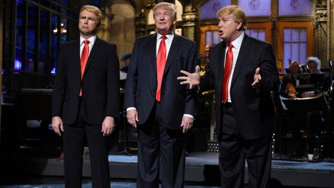 Trump is flanked by impersonators Taran Killam, left, and Darrell Hammond during his "Saturday Night Live" monologue on November 7, 2015.