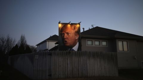 A giant Trump poster is illuminated outside a home in Des Moines, Iowa, on January 28, 2016.