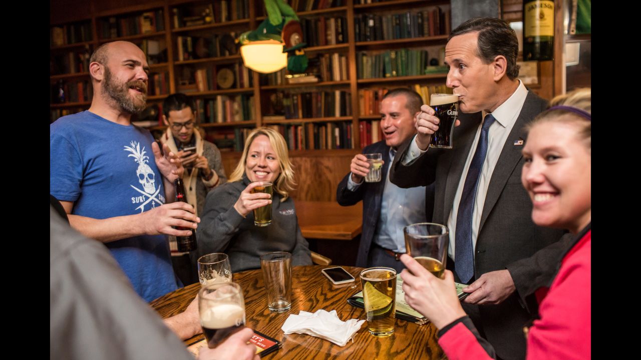 Republican presidential candidate Rick Santorum, second from right, drinks a beer at a pub in Waukee, Iowa, on January 28, 2016. The former U.S. senator from Pennsylvania also ran in 2012.