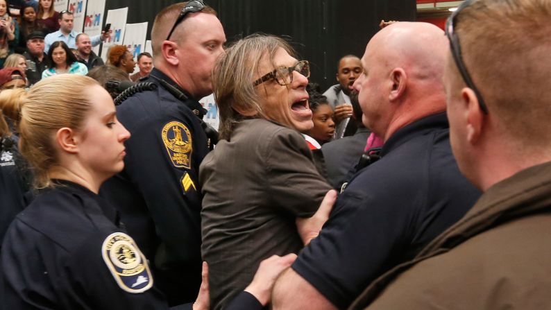 Christopher Morris, a photographer on assignment for Time magazine, is escorted by police during a Trump rally in Radford, Virginia, on February 29, 2016. Morris said a Secret Service agent choked him and slammed him to the ground as he tried to leave a media pen at the event. <a href="index.php?page=&url=http%3A%2F%2Fwww.cnn.com%2F2016%2F02%2F29%2Fpolitics%2Fdonald-trump-event-protest-rally%2F" target="_blank">The incident was caught on video.</a>