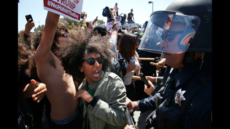 Protester Biseat Yawkal yells as she is pushed by police outside of the California Republican Convention on April 29, 2016. Trump protesters -- some of whom wore bandanas over their faces and carried Mexican flags -- <a href="index.php?page=&url=http%3A%2F%2Fwww.cnn.com%2F2016%2F04%2F29%2Fpolitics%2Fdonald-trump-protests-republican-convention-california%2F" target="_blank">blocked off the road </a>in front of the Hyatt Regency, forcing Trump's motorcade to pull over along a concrete median outside the hotel's back entrance. Trump and his entourage got out and walked into the building.
