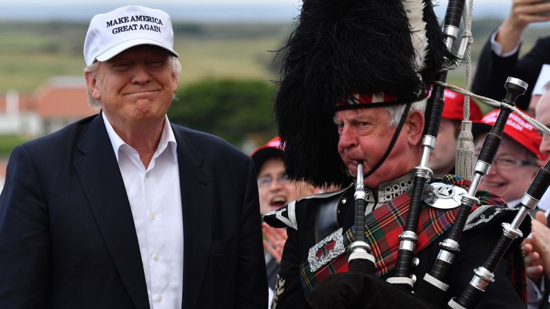 A man plays the bagpipes next to Trump after the candidate arrived at his Turnberry golf resort in Scotland on June 24, 2016. Trump <a href="index.php?page=&url=http%3A%2F%2Fwww.cnn.com%2F2016%2F05%2F26%2Fpolitics%2Fdonald-trump-has-delegates-to-clinch-gop-nomination%2F" target="_blank">became the GOP's presumptive nominee</a> in May.