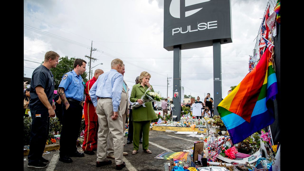 Clinton, accompanied by first responders and U.S. Sen. Bill Nelson, visits a memorial outside of the Pulse nightclub in Orlando on July 22, 2016. The nightclub was the site of a June shooting that killed 49 people.