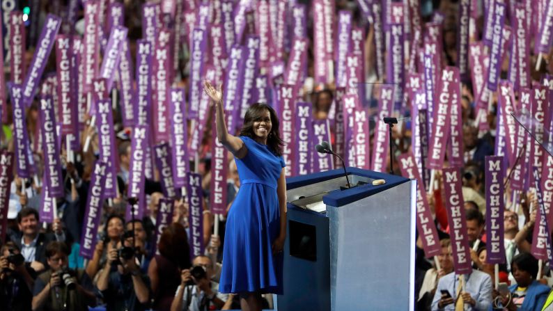 First lady Michelle Obama waves to delegates in Philadelphia as <a href="index.php?page=&url=http%3A%2F%2Fwww.cnn.com%2F2016%2F07%2F25%2Fpolitics%2Fmichelle-obama-dnc-speech%2Findex.html" target="_blank">she speaks on the first day of the Democratic National Convention</a> on July 25, 2016. Obama cast the presidential race as one between a positive role model for children and a damaging one.