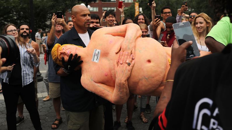 An employee from the New York City Department of Parks & Recreation removes <a href="index.php?page=&url=http%3A%2F%2Fwww.cnn.com%2F2016%2F08%2F18%2Fpolitics%2Fnaked-donald-trump-statue-nyc-parks-department%2Findex.html" target="_blank">a statue of a naked Trump</a> from Union Square on August 18, 2016.
