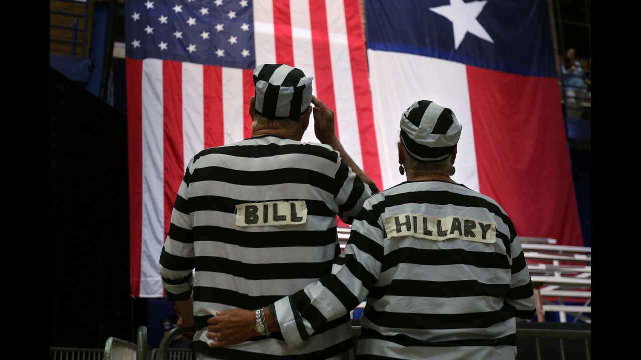 Trump supporters wear prison costumes with the Clintons' names on them at a campaign rally in Austin, Texas, on August 23, 2016.