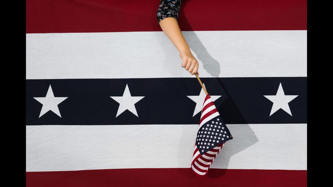 A Clinton supporter waves a flag during a campaign event in Reno, Nevada, on August 25, 2016.