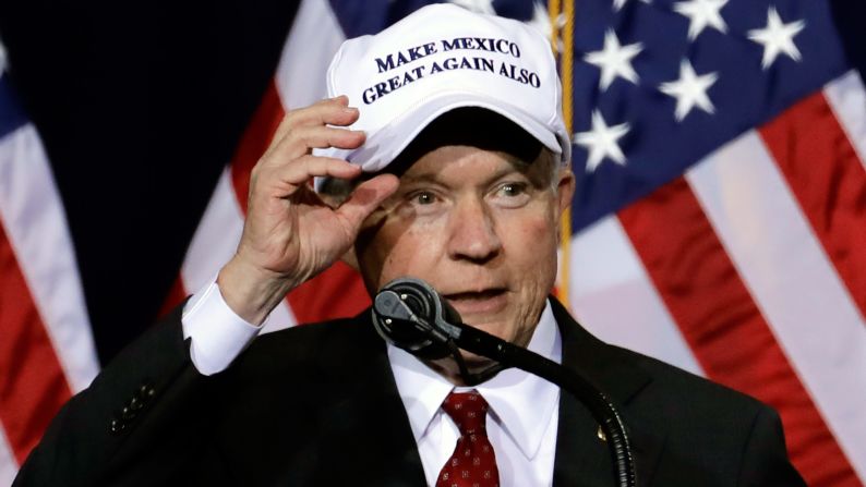 U.S. Sen. Jeff Sessions shows off his hat while he speaks during a Trump rally in Phoenix on August 31, 2016. <a href="index.php?page=&url=http%3A%2F%2Fwww.cnn.com%2F2016%2F09%2F01%2Fpolitics%2Fnew-trump-hat-trnd%2F" target="_blank">The hat</a> is related to Trump's campaign slogan, "Make America Great Again," and its debut came hours after Trump traveled south of the border to meet Mexico's President.