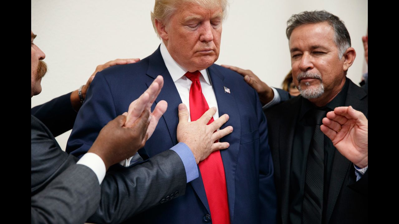 Pastors pray with Trump during the Republican nominee's visit to Las Vegas on October 5, 2016.