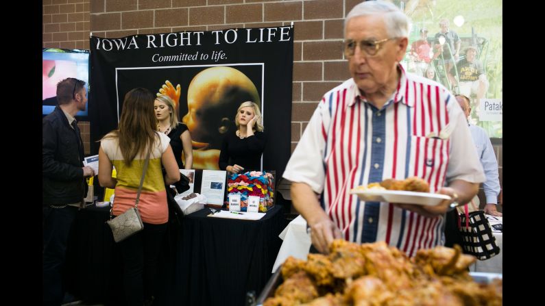 A man helps himself to a fried chicken buffet near an anti-abortion display at the Iowa Faith & Freedom Coalition's<a href="index.php?page=&url=http%3A%2F%2Fwww.cnn.com%2Finteractive%2F2015%2F10%2Fpolitics%2Ffear-voting-christian-right%2F" target="_blank"> Fall Family Dinner</a> in September 2015. Defunding Planned Parenthood was a popular topic during the forum. 