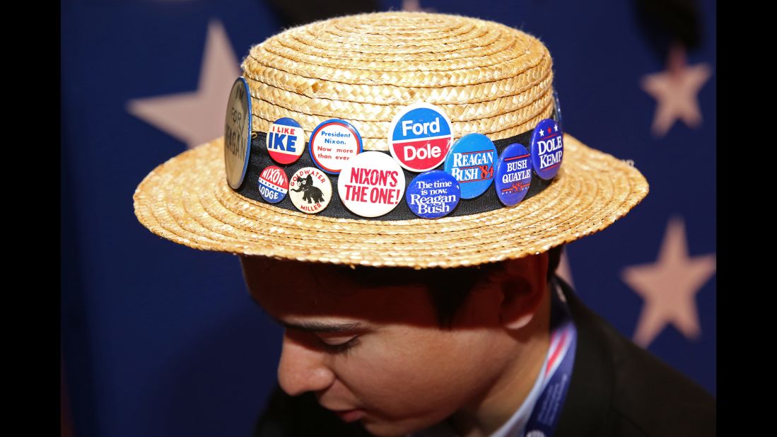 A Republican's hat carries old campaign buttons at the convention in Cleveland.
