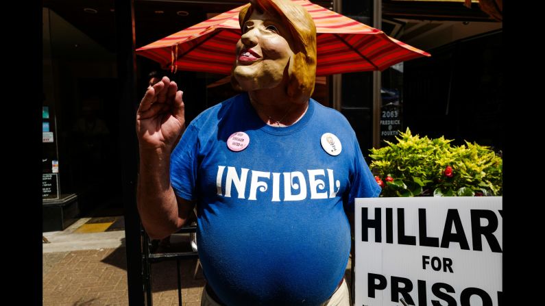 A protester wears a Hillary Clinton mask <a href="index.php?page=&url=http%3A%2F%2Fwww.cnn.com%2F2016%2F07%2F20%2Fpolitics%2Fgallery%2Foutside-rnc-van-agtmael%2Findex.html" target="_blank">outside the Republican National Convention.</a> CNN sent photographer Peter van Agtmael into the crowds of both conventions to get a handle on what it's like away from the politicians and delegates.