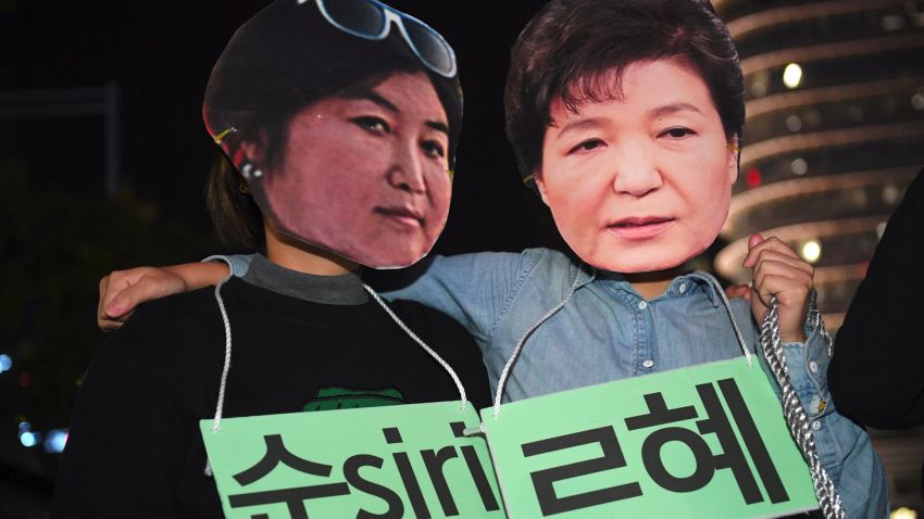 Protestors wearing masks of South Korean President Park Geun-Hye (R) and her confidante Choi Soon-Sil (L) pose for a performance during a rally denouncing a scandal over President Park's aide in Seoul on October 27, 2016.
South Korean prosecutors on October 27 set up a high-powered "task-force" to probe a widening scandal involving alleged influence-peddling by a close confidante of President Park Geun-Hye. Choi Soon-Sil, an enigmatic woman with no government position, was already part of an investigation into allegations that she used her relationship with the president to strong-arm conglomerates into multi-million dollar donations to two non-profit foundations.
/ AFP / JUNG YEON-JE (Photo credit should read JUNG YEON-JE/AFP/Getty Images)