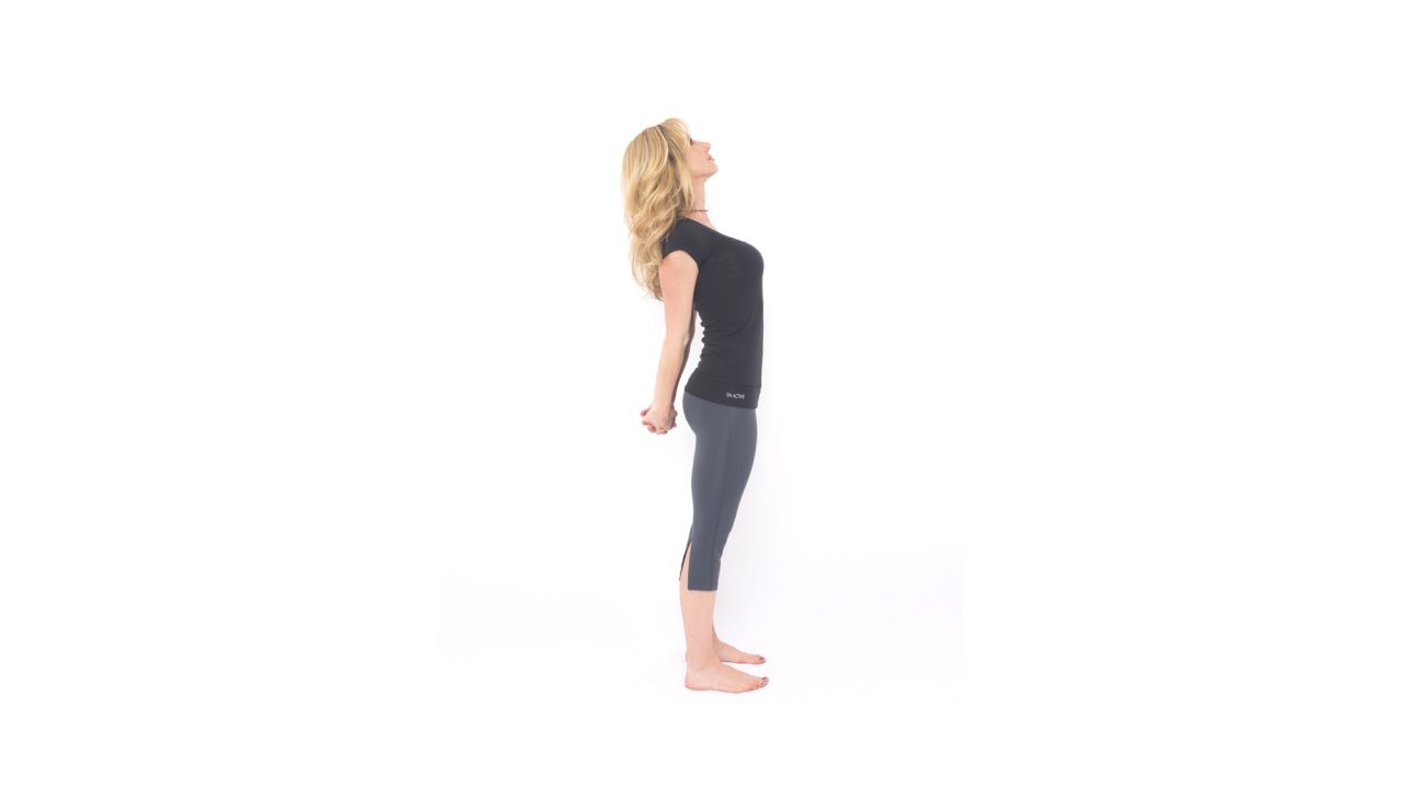 To release upper-body tension, from standing, clasp your hands behind your back and straighten your arms to the best of your ability as you look up, opening your chest, neck and shoulders. Hold the posture for a few breaths. Release and repeat.