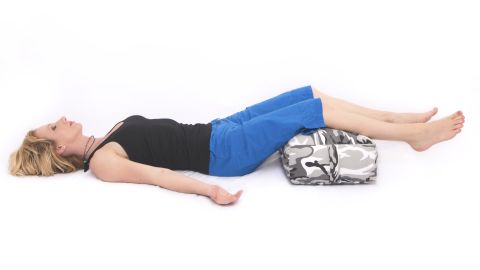Lie down comfortably with a bolster or pillow under your legs and set a timer for a desired length of time; eight to 10 minutes is a good starting point. Close your eyes. Notice your breathing and the sense of release and comfort in your legs as they rest on the bolster. Remain committed to simply being in your body in your relaxed posture.