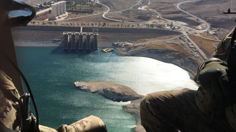 US troops look out from a Blackhawk helicopter over Mosul Dam, retaken from ISIS but still facing structural problems. 