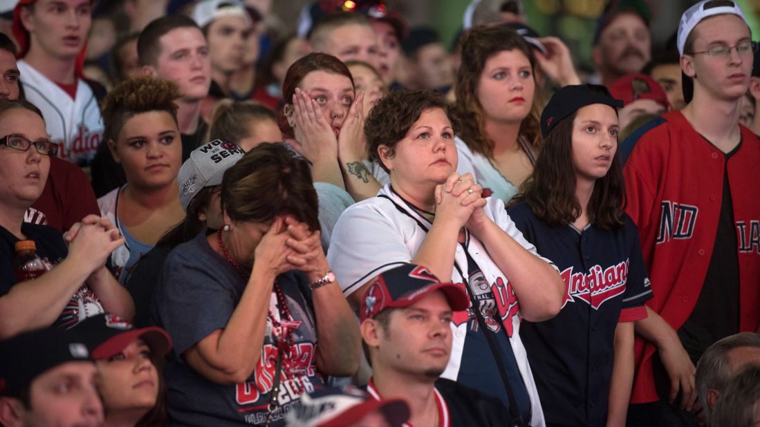 Indians fans react as they watch outside of Progressive Field during Game 7.