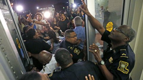 Police keep protesters from pushing through a door, before a debate for Louisiana candidates for the U.S. Senate, at Dillard University in New Orleans on Wednesday.