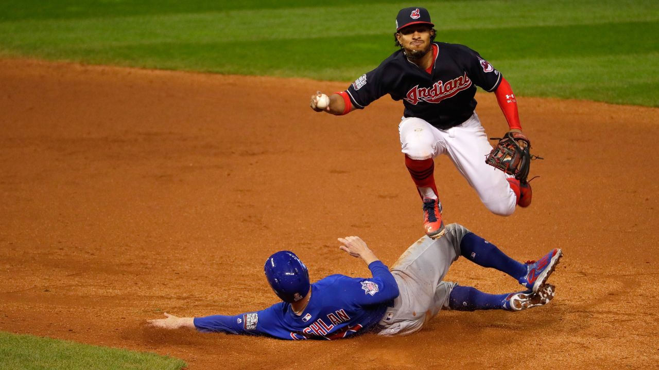 Francisco Lindor of the Indians jumps over Chris Coghlan of the Cubs in the ninth inning in Game 7. 