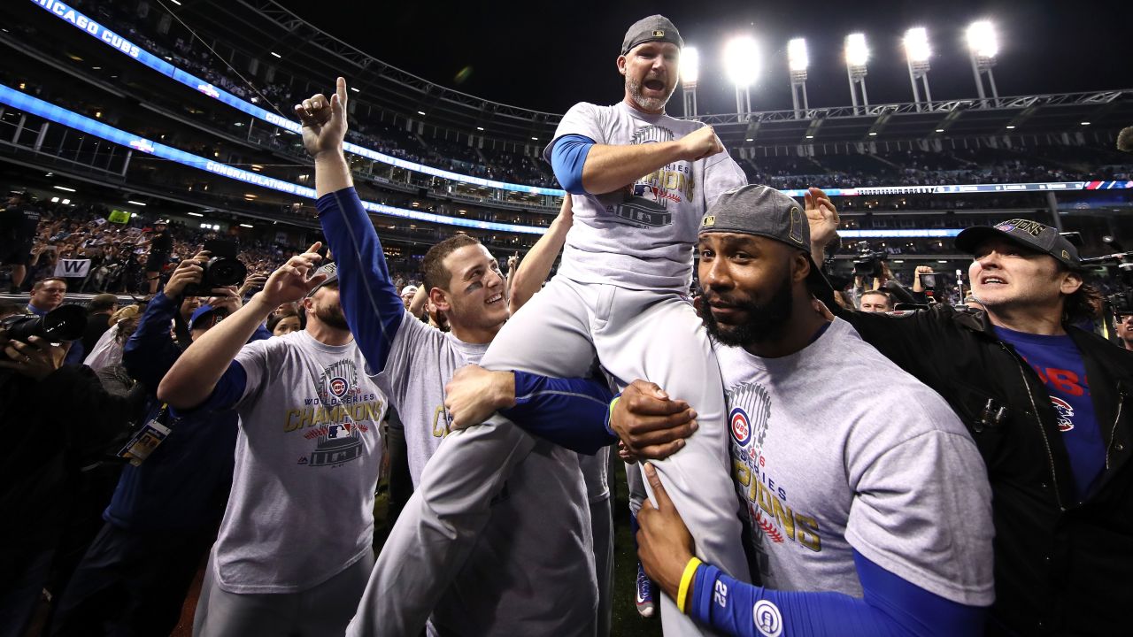 Anthony Rizzo, David Ross, and Jason Heyward of the Cubs celebrate with actor John Cusack (far right).