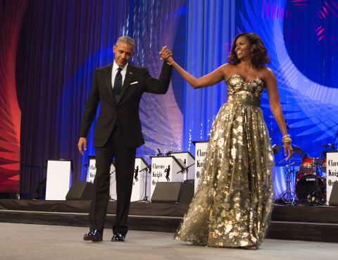 Obama arrives on stage alongside President Obama during the Congressional Black Caucus Foundation's Phoenix Awards Dinner on September 17, 2016.