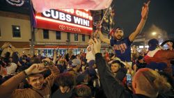 Chicago Cubs fans celebrate in front of  Wrigley Field in Chicago on Wednesday, Nov. 2, 2016, after the Cubs beat the Cleveland Indians 8-7 in Game 7 of the Major League World Series in Cleveland. (AP Photo/Charles Rex Arbogast)