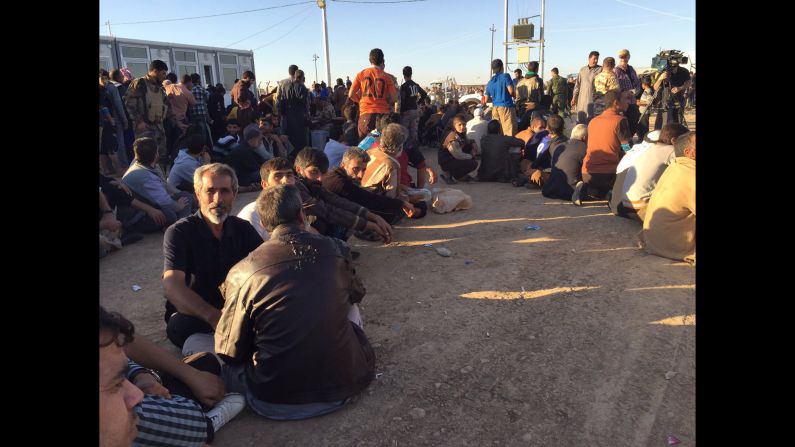 At one camp, where thousands from Mosul arrived Thursday, men and boys waited to be processed. 