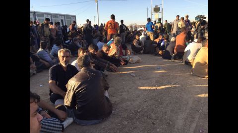 At one camp, where thousands from Mosul arrived Thursday, men and boys waited to be processed. 