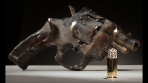 Nicholas Varney made "Onegin" with a gun and created a bullet out of 18-karat gold and diamonds. "Hopefully," Varney said, "the brightness of the bullet sheds light on the gun and all of its significance within New Orleans, a city known for its singular splendor and its foil. It is a gem, after all."