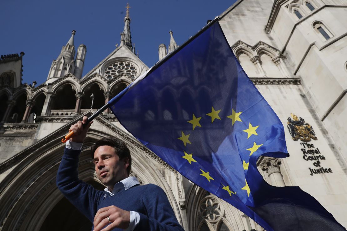 Phil Jones, 'People's Challenge' member waves an EU flag outside the Royal Courts of Justice.