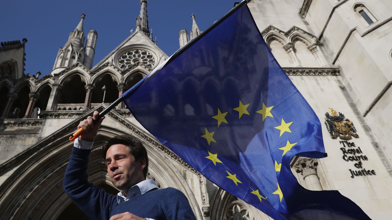 Phil Jones, 'People's Challenge' member waves an EU flag outside the Royal Courts of Justice.