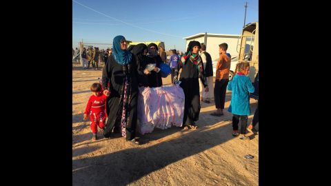 Women and children arrived at the Khazir camp east of Mosul with stories of horror under ISIS.   A young man said ISIS had placed roadside bombs in front of their homes. "There are snipers on the rooftops," he said. <br />