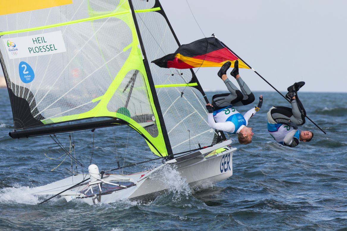 German duo Erik Heil and Thomas Ploessel perform a synchronized back flip after their eighth place in the final race in the Rio Olympics 49er class that earned them a bronze medal. Gilles Martin-Raget managed to snap the moment.
