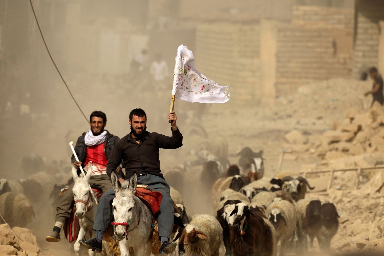 A man fleeing the village of Bazwaya carries a white flag as he arrives at a checkpoint on November 1.