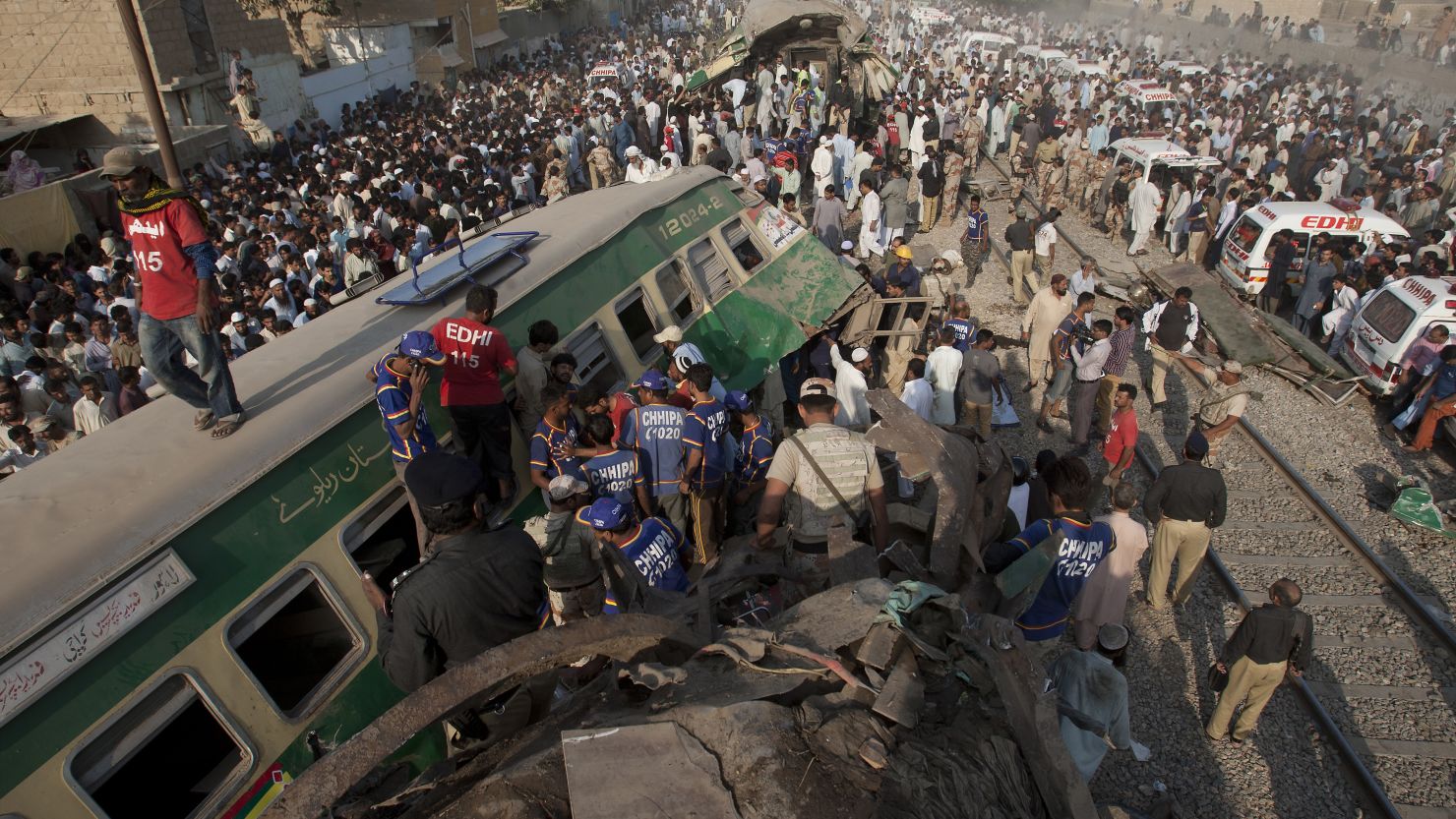 Bystanders search the wreckage for victims of a train crash in Karachi, Pakistan, November 3. 