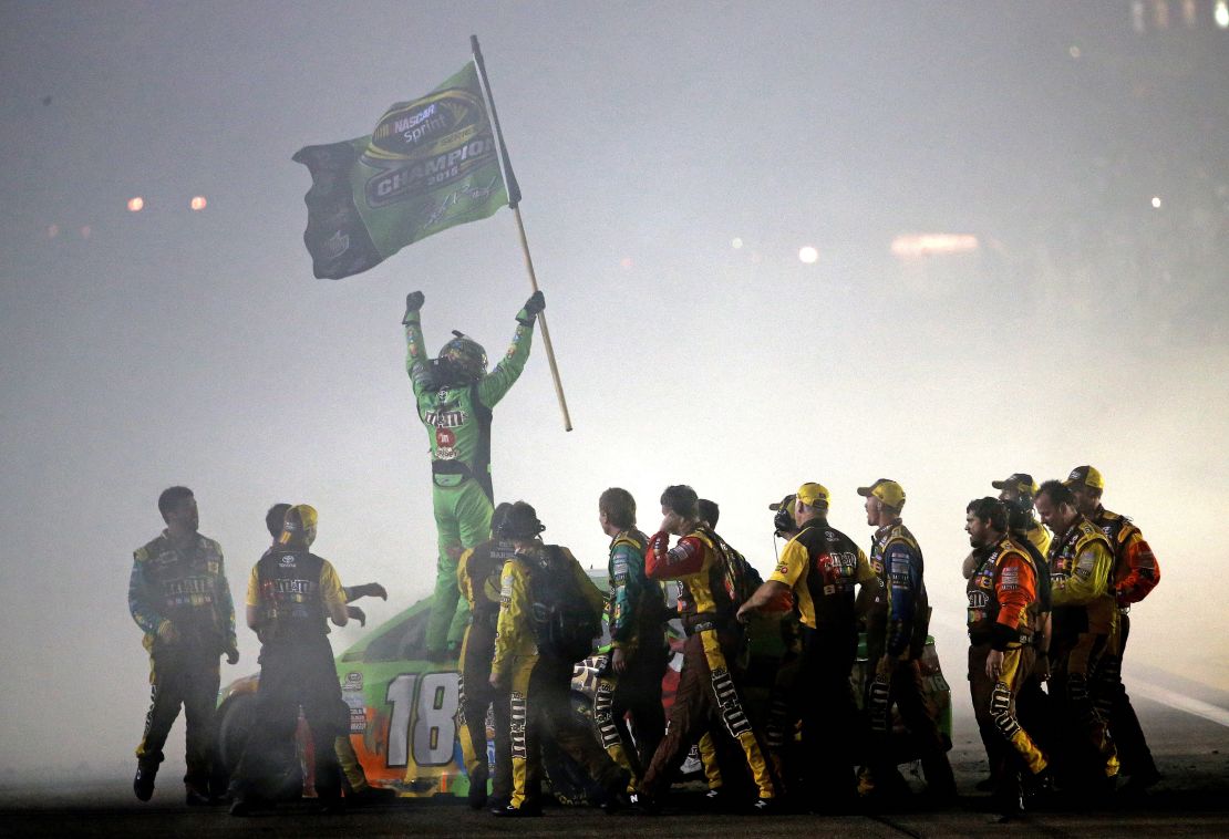 Kyle Busch celebrates with his crew after winning the series championship at Homestead-Miami Speedway on November 22, 2015.