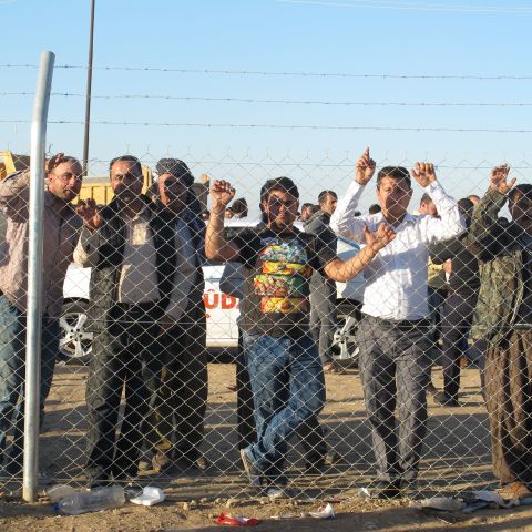 Fences separated the women, children and established residents of the camp from the men and boys who arrived Thursday.