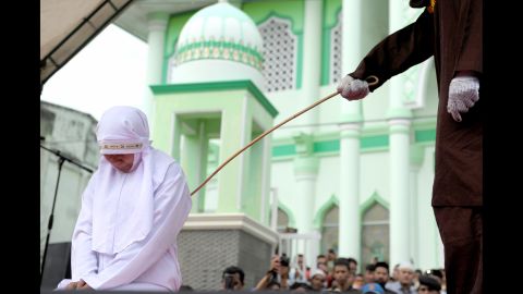 <strong>October 31:</strong> A woman is caned in Banda Aceh, Indonesia. The province of Aceh is strictly Muslim and is the only province in the country implementing Sharia law. Public canings happen there regularly and often attract huge crowds.