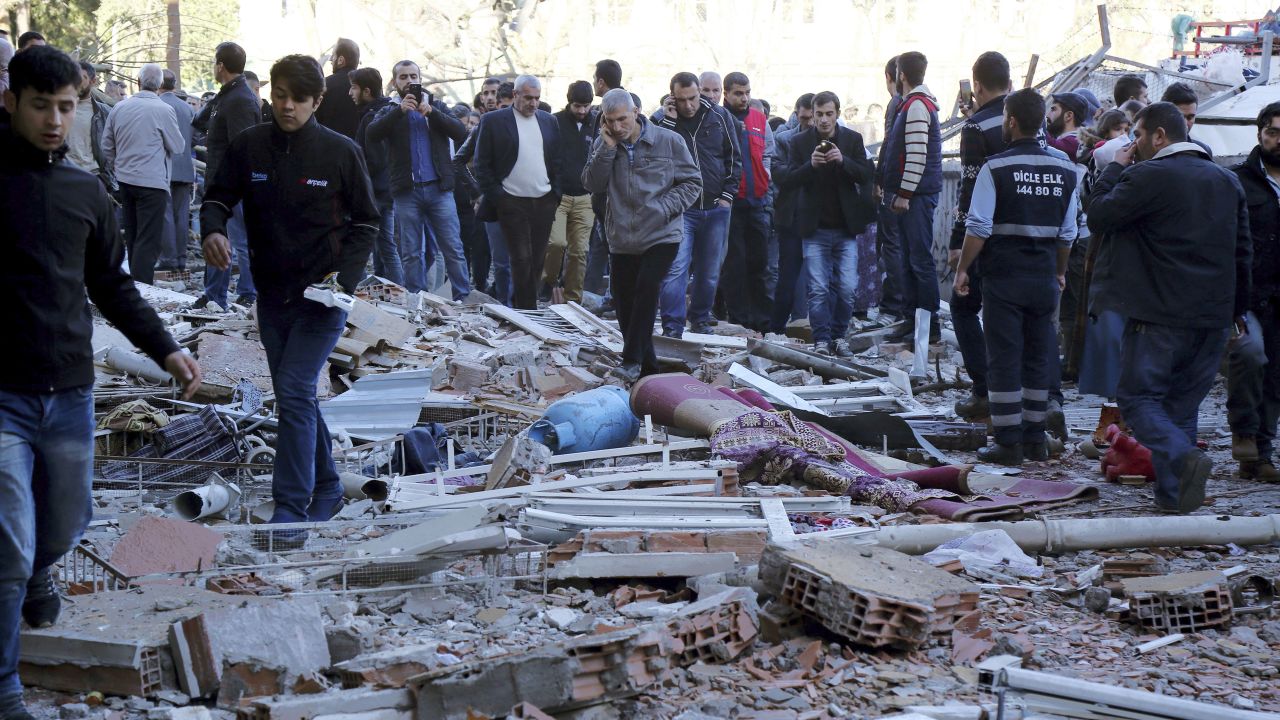 People view the damage from an explosion in southeastern Turkish city of Diyarbakir, early Friday, Nov. 4, 2016. A large explosion hit the largest city in Turkey's mainly Kurdish southeast region on Friday, wounding several people, the state-run Anadolu Agency reported. Turkish authorities have imposed a temporary blackout on coverage of the blast occurred in Diyarbakir on Friday, citing public order and national security reasons. (AP Photo/Mahmut Bozarslan)