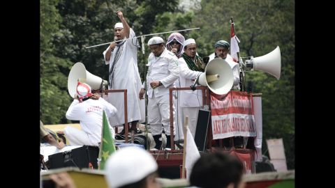 Muslim leaders broadcast their message as they march past Jakarta's governor's office on November 4.