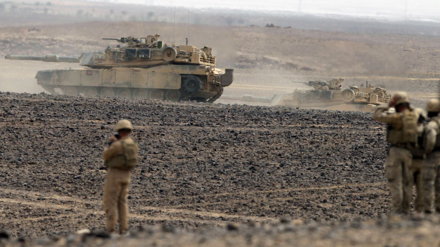 Soldiers watch tanks advancing as they take part in joint Jordan-US maneuvers during the "Eager Lion" military exercises in Mudawwara, near the border with Saudi Arabia, some 280 kilometers south of the Jordanian capital, Amman, on May 18, 2015. 