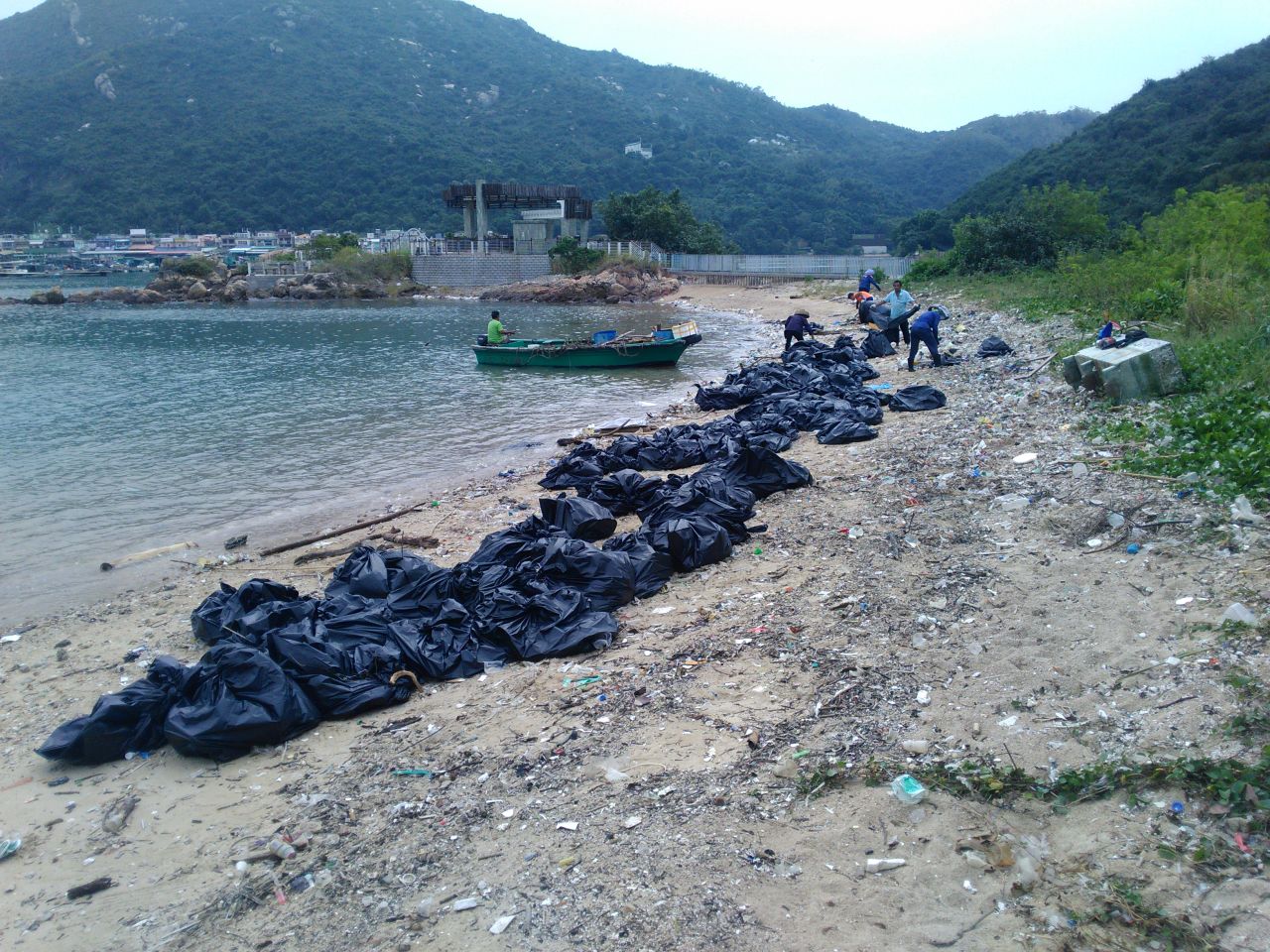 Trash being cleaned up on Sok Ku Wan beach.