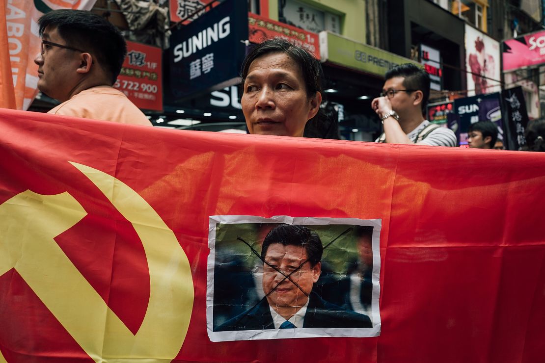 A protester displays a photo of Chinese President Xi Jinping during a rally to support the Hong Kong booksellers.