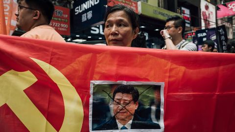 A protester displays a photo of Chinese President Xi Jinping during a rally to support the Hong Kong booksellers.