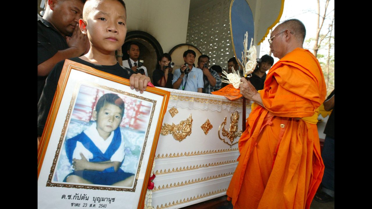 Captain Boonmanuch, a young boy who lived in northern Thailand, may have played a small role in the spread of H5N1 avian flu, or bird flu, in 2003. He was the first human death from bird flu in Thailand during the outbreak. Patipahat Boonmanuch, Captain's brother, held a picture of him during his funeral.