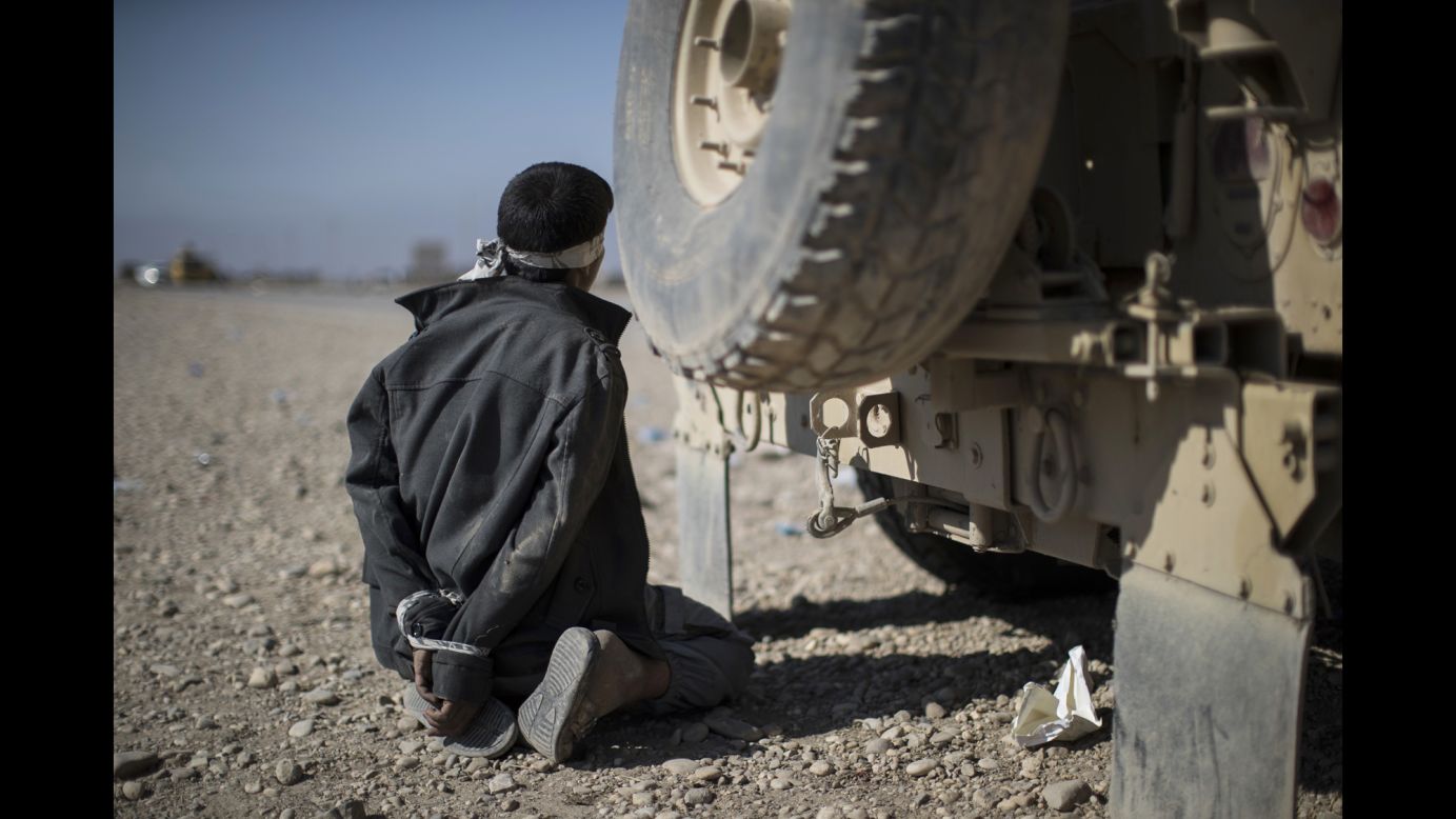 A suspected member of ISIS is detained at a checkpoint near Bartella, Iraq, on November 4.