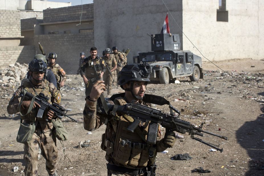 Iraqi soldiers patrol an alley on the outskirts of Mosul on Friday, November 4.