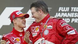 SUZUKA, JAPAN:  World champion Michael Schumacher (L) of Germany is congratulated by the team's technical director Ross Brawn (R) during an awarding ceremony in the Formula One Japanese Grand Prix at Suzuka Circuit in Suzuka, central Japan, 10 October 2004. Schumacher won the 53-lap race with a time of 1 hour 24 minutes and 26.985 seconds.          AFP PHOTO/Toru YAMANAKA  (Photo credit should read TORU YAMANAKA/AFP/Getty Images)