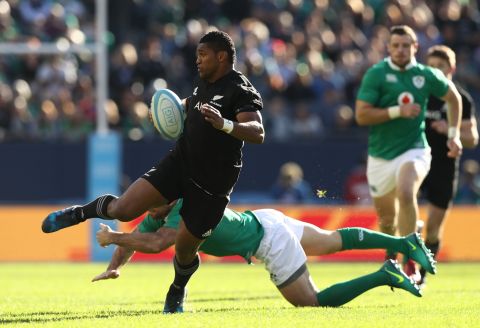 Waisake Naholo of New Zealand evades a tackle from Simon Zebo before setting up the opening try for his team. 