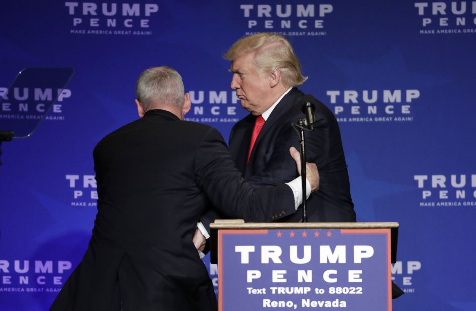 Members of the Secret Service rush Trump off the stage in Reno.